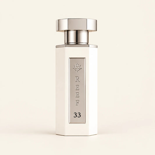 REEF 33 White Eau de Parfum 100ml on a plain ivory studio background